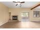Living room with tile floors, fireplace, and sliding glass doors leading to the backyard at 38913 N 21St Ave, Phoenix, AZ 85086
