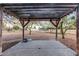 Wooden pergola creates a shaded patio area in backyard at 38913 N 21St Ave, Phoenix, AZ 85086