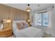 Bright bedroom with wood accent wall, plush bedding, and window with blinds at 4529 E Coyote Wash Dr, Cave Creek, AZ 85331