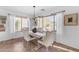 Dining room with a wooden table, beige chairs, and large windows at 4529 E Coyote Wash Dr, Cave Creek, AZ 85331
