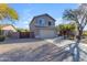 Two-story house with a beige exterior, two-car garage, and desert landscaping at 4529 E Coyote Wash Dr, Cave Creek, AZ 85331