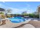 Stunning kidney-shaped pool with patio furniture and landscaping at 4529 E Coyote Wash Dr, Cave Creek, AZ 85331