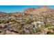 Aerial view of property showcasing a home with pool, modern garage, and mountain views at 4605 E Orange Dr, Phoenix, AZ 85018