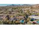 Aerial view of single-story home with pool and mountain backdrop; lush landscaping surrounds the property at 4605 E Orange Dr, Phoenix, AZ 85018