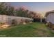 Landscaped backyard with a lush lawn and gated entrance at 4605 E Orange Dr, Phoenix, AZ 85018