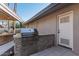 Modern outdoor grill with stonework and storage at 4605 E Orange Dr, Phoenix, AZ 85018