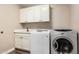 Laundry room with washer, dryer, and white cabinets at 4605 E Orange Dr, Phoenix, AZ 85018