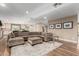 Open concept living area with a large sectional sofa and hardwood floors at 4605 E Orange Dr, Phoenix, AZ 85018