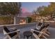 Outdoor patio with fire pit and seating area at sunset at 4605 E Orange Dr, Phoenix, AZ 85018