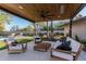 Covered patio features wooden seating and ceiling fan at 4605 E Orange Dr, Phoenix, AZ 85018