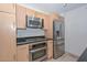 Modern kitchen with stainless steel appliances and light wood cabinets at 4808 N 24Th St # 1123, Phoenix, AZ 85016