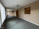 Spacious living room with neutral carpeting and a ceiling fan at 5125 E Emelita Cir, Mesa, AZ 85206