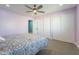 Bedroom with light purple walls, ceiling fan and ample closet space at 5781 W Ross Dr, Chandler, AZ 85226