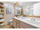 Double vanity bathroom with a large mirror and shelves at 609 N Cobblestone St, Gilbert, AZ 85234