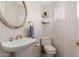 Small bathroom with pedestal sink and toilet at 6945 E Glenrosa Ave, Scottsdale, AZ 85251