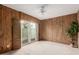 Bedroom with wood-paneled accent wall and patio access at 6945 E Glenrosa Ave, Scottsdale, AZ 85251