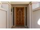 Ornate wood front door with decorative carvings and glass sidelights at 6945 E Glenrosa Ave, Scottsdale, AZ 85251