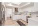 Modern white kitchen with stainless steel appliances and quartz countertops at 6945 E Glenrosa Ave, Scottsdale, AZ 85251