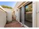 Private patio with brick flooring and wrought-iron gate at 6945 E Glenrosa Ave, Scottsdale, AZ 85251