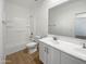 Clean bathroom with double vanity, a shower/tub combo, and tile floors at 703 W Magena Dr, San Tan Valley, AZ 85140