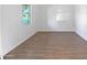 Simple bedroom with wood-look tile flooring at 703 W Magena Dr, San Tan Valley, AZ 85140