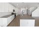 Modern kitchen with white cabinets, stainless steel appliances, and an island at 703 W Magena Dr, San Tan Valley, AZ 85140
