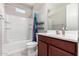 Bathroom with shower/tub combo, wood vanity, and tiled floor at 750 W Flintlock Way, Chandler, AZ 85286