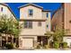 Tan three-story home with two-car garage and landscaping at 750 W Flintlock Way, Chandler, AZ 85286