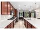 Open concept kitchen with stainless steel appliances and white cabinets at 750 W Flintlock Way, Chandler, AZ 85286