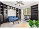 Home office with built-in shelving, comfortable seating, and large windows at 750 W Flintlock Way, Chandler, AZ 85286