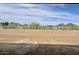 An empty backyard with a retaining wall and mountain views at 7638 W Rowel Rd, Peoria, AZ 85383