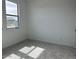 Bright bedroom featuring neutral carpet, white walls and a window providing plenty of natural light at 7638 W Rowel Rd, Peoria, AZ 85383
