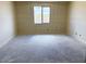 The unfinished bedroom features a neutral color palette, trim, and a blank canvas for your personal touches at 7638 W Rowel Rd, Peoria, AZ 85383