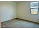 Cozy bedroom featuring neutral carpet, white walls and a window providing natural light at 7638 W Rowel Rd, Peoria, AZ 85383