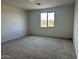 A carpeted bedroom with a scenic view from the window at 7638 W Rowel Rd, Peoria, AZ 85383