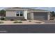 Single-story home with gray exterior, two-car garage, and desert landscaping at 7638 W Rowel Rd, Peoria, AZ 85383