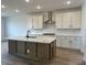 Modern kitchen with white cabinets, subway tile backsplash, and a large center island with sink at 7638 W Rowel Rd, Peoria, AZ 85383