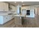Spacious kitchen featuring a large island, white cabinetry, and stainless steel appliances at 7638 W Rowel Rd, Peoria, AZ 85383