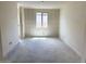 This unfinished living room has natural light, white trim, and a blank canvas for designing your dream space at 7638 W Rowel Rd, Peoria, AZ 85383