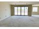Spacious living room featuring a large sliding glass door with stunning views of the natural environment at 7638 W Rowel Rd, Peoria, AZ 85383