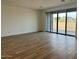 Open living room featuring wood-look tile flooring and sliding doors leading to the backyard at 7638 W Rowel Rd, Peoria, AZ 85383