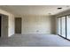 A spacious living room with a sliding glass door showcasing ample space and potential for customization at 7638 W Rowel Rd, Peoria, AZ 85383