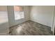 Bright bedroom with wood-look flooring and window at 9817 N 43Rd Dr, Glendale, AZ 85302