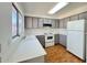 Kitchen features gray cabinets, white countertops, and wood-look floors at 9817 N 43Rd Dr, Glendale, AZ 85302