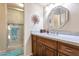 Bathroom with granite countertop, large mirror, and walk-in shower at 10023 E Sunnyslope E Ln, Scottsdale, AZ 85258