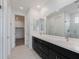Double vanity bathroom with dark cabinetry and a large mirror at 10236 E Ursula Ave, Mesa, AZ 85212