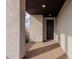Covered entryway with modern door and brick tile flooring at 10236 E Ursula Ave, Mesa, AZ 85212