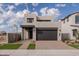 Modern two-story home with dark garage door and landscaped front yard at 10236 E Ursula Ave, Mesa, AZ 85212