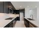 Modern kitchen with dark cabinetry and stainless steel appliances at 10236 E Ursula Ave, Mesa, AZ 85212