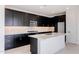 Sleek kitchen with dark cabinetry, quartz countertops and island at 10236 E Ursula Ave, Mesa, AZ 85212